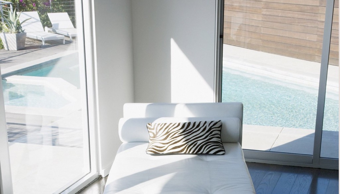 Bright modern hotel room with a pool view, near the arena