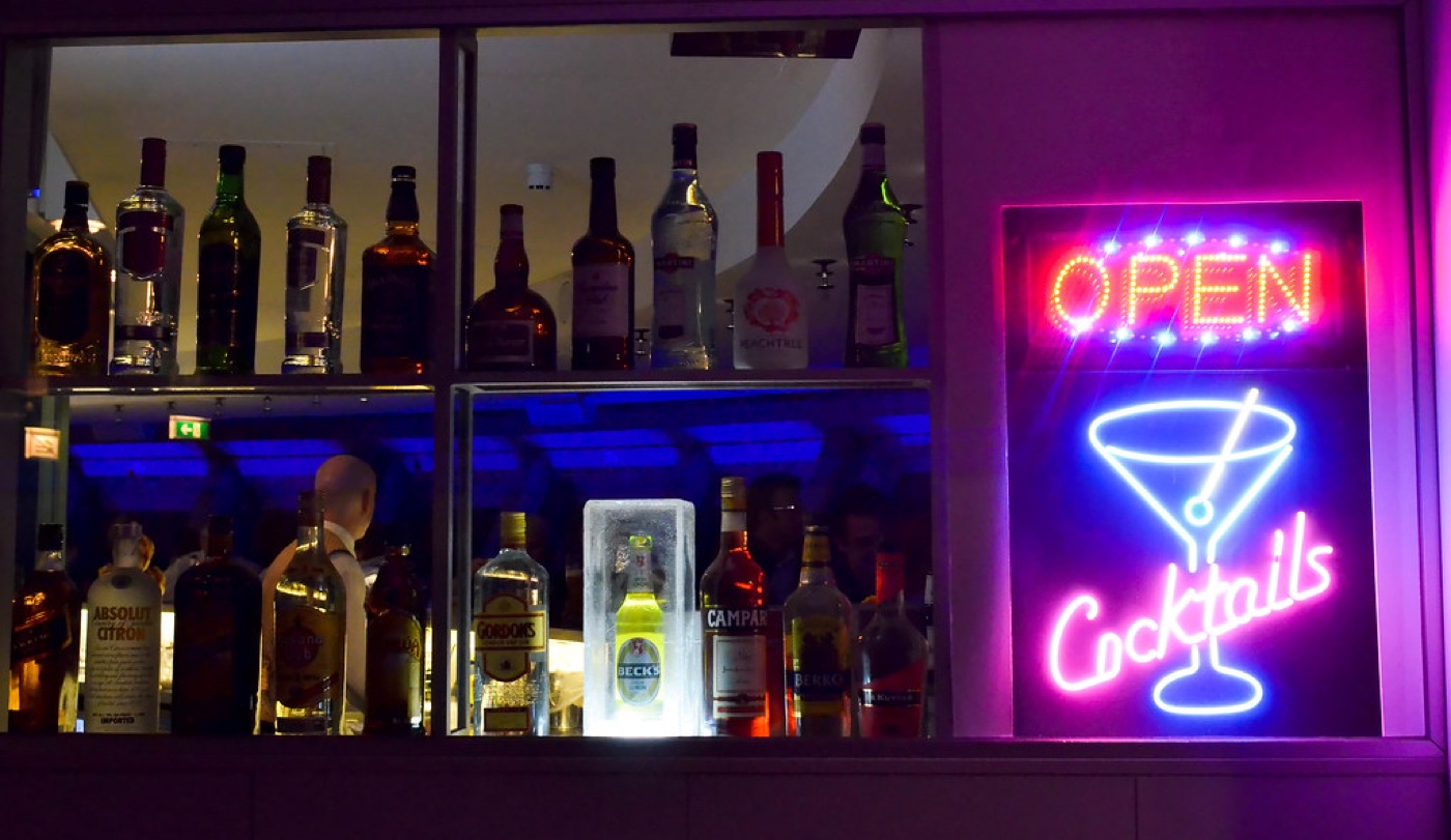 A neon-lit cocktail bar at night
